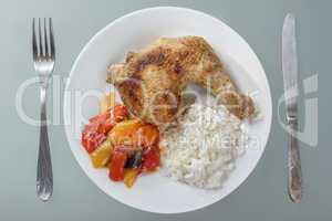 Fried chicken leg with rice and vegetables