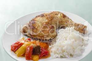 Fried chicken leg with rice and vegetables