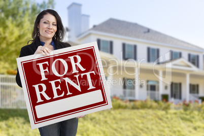 Hispanic Female Holding For Rent Sign In Front of House
