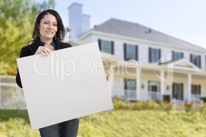 Hispanic Female Holding Blank Sign In Front of House