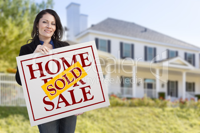 Woman Holding Sold Home Sale Sign in Front of House