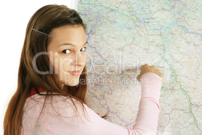 Teenage girl pointing at map