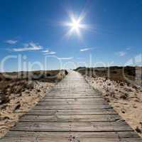 Wooden Walkway Leading to the Beach over Sand Dunes