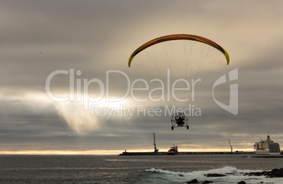Motorized Paraglider Flight above Ocean Harbor