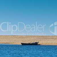 Solo Rowboat Moored on Sandy Beach