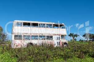 Rusty Abandoned Double-Decker Bus Standing in a Field
