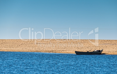 Solo Rowboat Moored on Sandy Beach