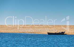 Solo Rowboat Moored on Sandy Beach