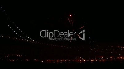 Firework at Night near Illuminated Bridge, black sky