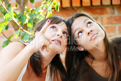 Mother and daughter looking up