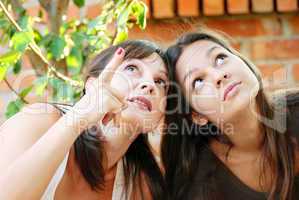 Mother and daughter looking up