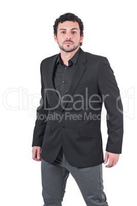 Young man in black jacket poses at studio