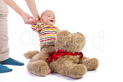 baby boy over plush dog on white