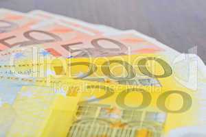 Close-up of 200 and 50 Euro banknotes on the table