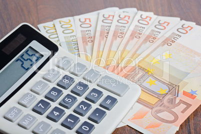 Calculator and banknotes on the table