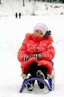 pretty girl sitting on the sledge