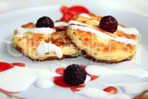 cheese cakes on the plate with raspberry