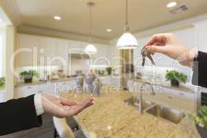 Handing Over New House Keys Inside Beautiful Kitchen