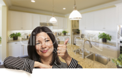 Hispanic Woman With Thumbs Up in Beautiful Custom Kitchen