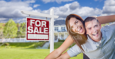 Military Couple In Front of Home with For Sale Sign