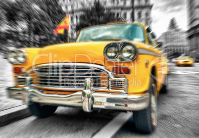 Blurred picture of fast moving vintage Yellow Cab in Lower Manha