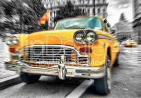 Blurred picture of fast moving vintage Yellow Cab in Lower Manha