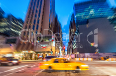 Blurred picture of Yellow Cab speeding up in the night, New York