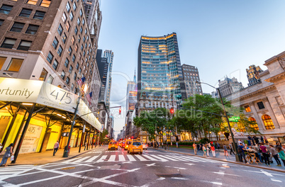 NEW YORK CITY - JUNE 8, 2013: Tourists and traffic on Fifth Aven