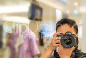 Tourist taking pictures with camera indoor