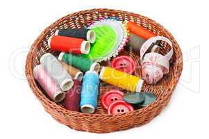 thread and buttons in a basket