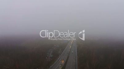 Flying over the highway in the fog