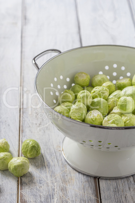 Brussels sprouts in a sieve on a table