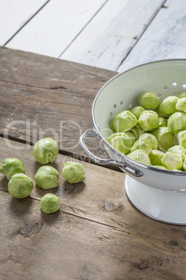 Brussels sprouts in a sieve on a table