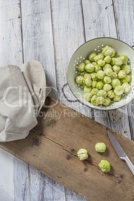 Brussels sprouts in a sieve on a table