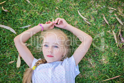 Caucasian little girl lay on grass
