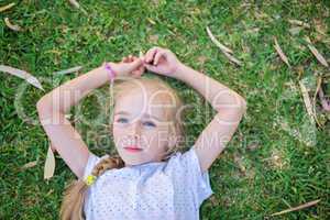 Caucasian little girl lay on grass
