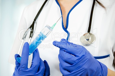 Woman doctor with gloves holding medical injection syringe and s