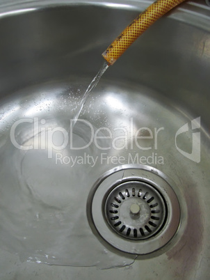 Metal sink and plastic hose