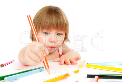 Little baby girl draws pencil