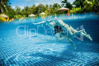 Couple floating in the pool on holiday