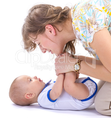 baby boy and mother lying on white floor