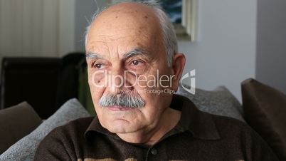 portrait of thinking senior man at home