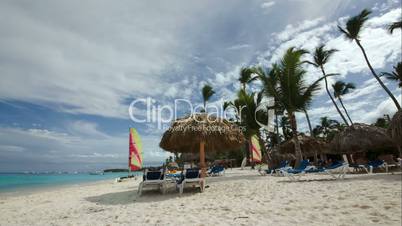 Tropical beach with chaise-longues and sun umbrellas