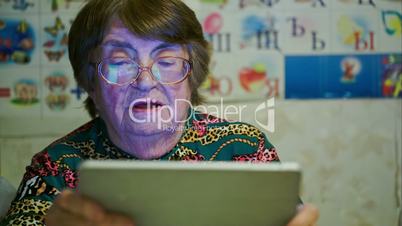 Senior woman using touch pad and talking