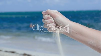 Sand pouring from female hand