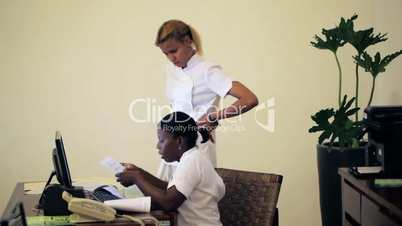 Two women receptionists working at beauty spa