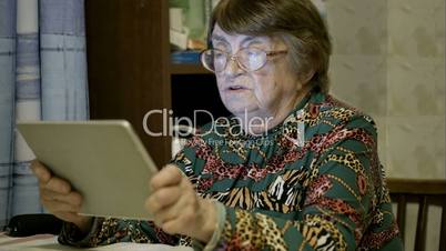 Senior woman using touch pad and talking