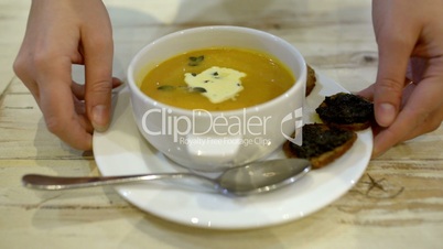 Serving of soup with bruschetta in cafe or restaurant