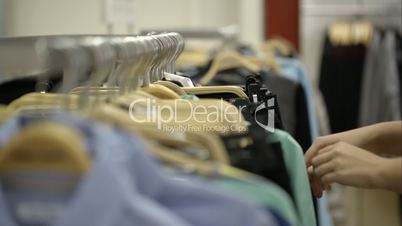 Woman looking over clothes in the store