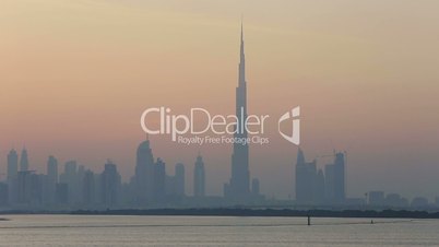 view of Dubai skyscraper and Burj Khalifa at sunset